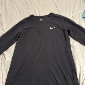 Grey long sleeve nike shirt. Has 2 small stains on the front.